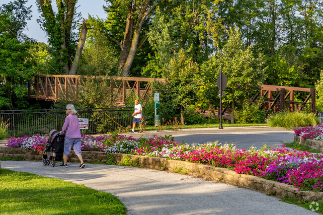 Old Silk Stocking residents walk along the path near Wildcat Creek in Foster Park.