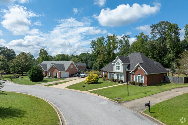 Brick homes line quiet cul-de-sacs in Woodland Forrest.