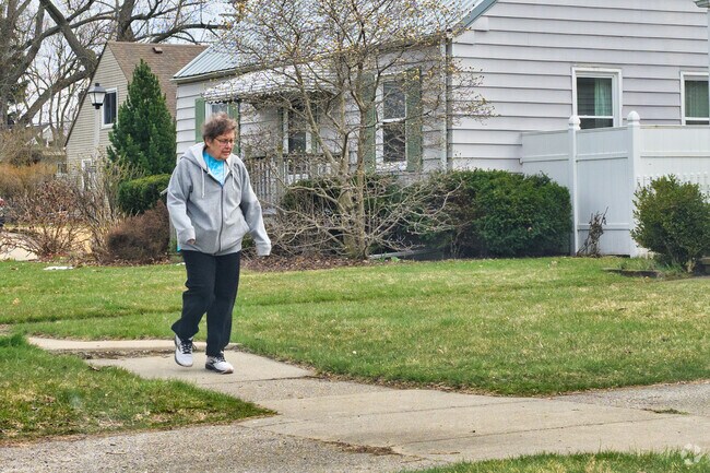 A woman takes a pleasant walk along Quentin Park's quiet streets.
