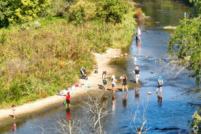 Residents of Springbrook Prairie enjoy playing in the DuPage River.
