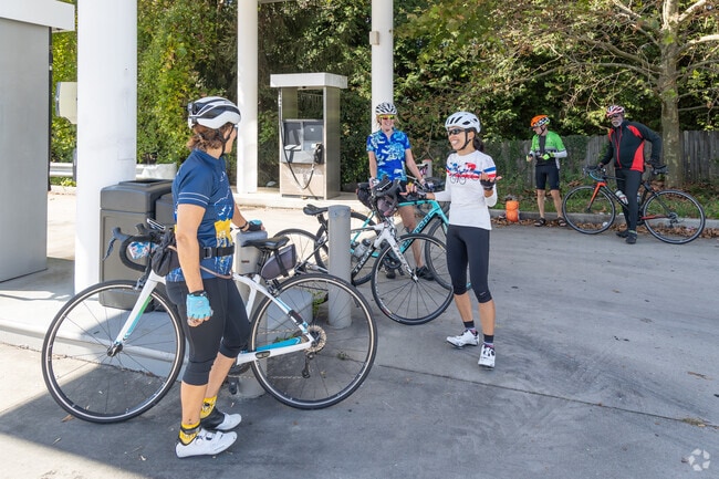 A group of cyclists rests at a Harwood gas station before heading to the trails.
