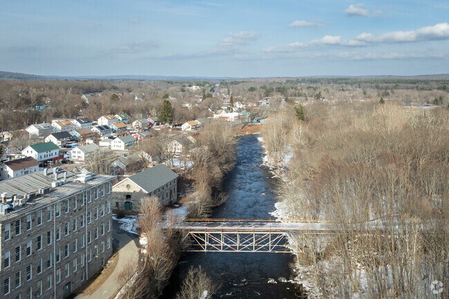 Willimantic, CT, features several bridges, including the Victorian Foot Bridge, with stunning views of the Willimantic River.