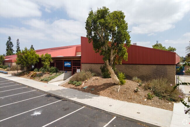 Main school building with bright red roof.
