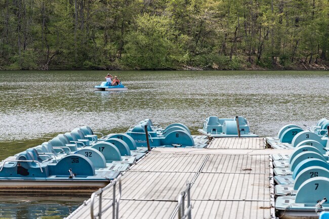 Couples enjoy time on the water in front of the Twin Lakes Activity Center near Unity Township.