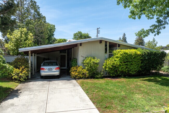Original Eichler design shines in this Fairmeadow home with a deep carport and open glass panel.