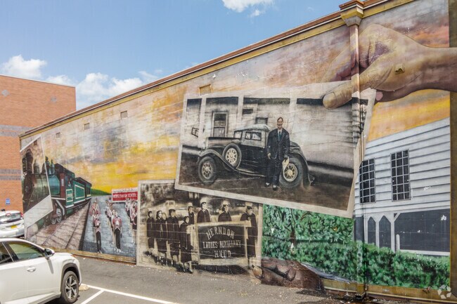 Murals along the sides of buildings depict a glimpse of the history of Herndon, VA