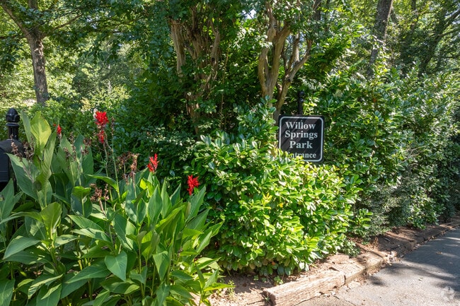 Lush landscaping and wooded pathways invite you into the peaceful retreat of Willow Springs Park.
