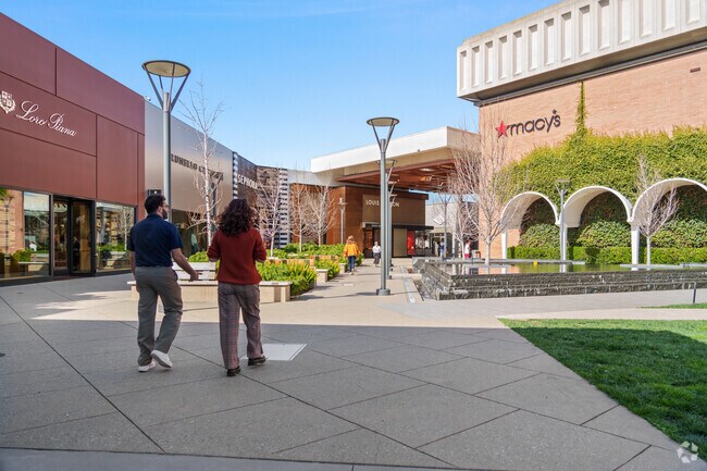 Leisurely shopping in Stanford Shopping Center's sunshine near Lindenwood.
