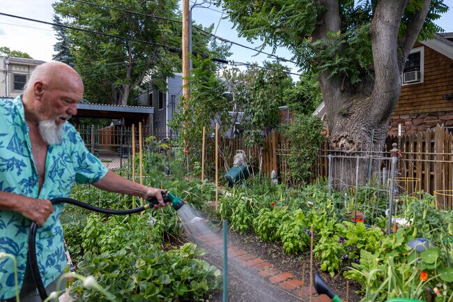 A local loves to water the garden every day in Fortune Park.