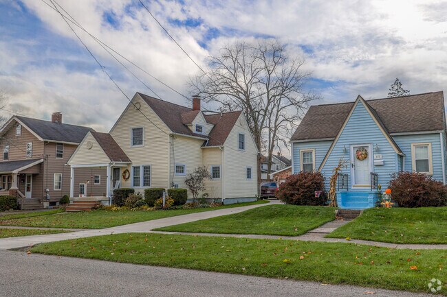 A colorful row of bungalows faces Newton Falls City Park, in Newton Falls.