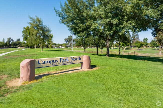 Campus Park North is a wide open park in Bakersfield, with lush green grass and mature trees.