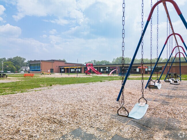 Pinewood Elementary School swings are aplenty so kids can have fun together.