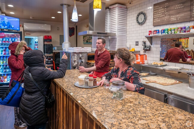 Plain pizza pies are the most popular item at Sam's Pizza in Kingsbridge.