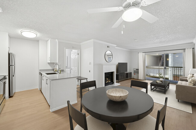 Renovated Package I kitchen, living, and dining area with hard surface flooring