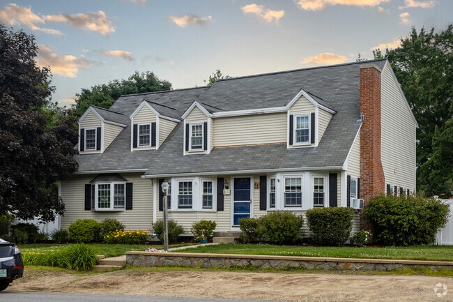 A cape-style house with dormered windows stands in Manchester's Mast Road neighborhood.
