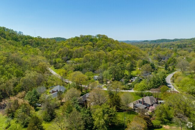 Otter Creek is amidst large rolling hills where homes sit at the base.