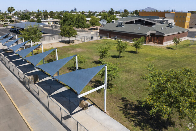 Children of Thew Elementary School in Tempe can wait for the bus under shade structures.