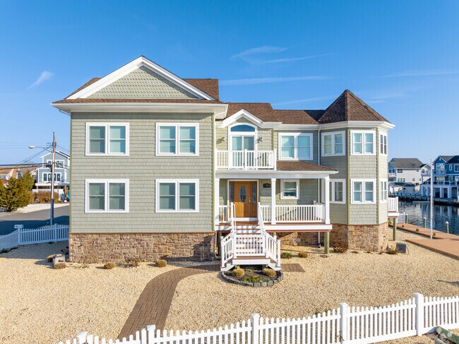 This elegant custom-built waterfront home showcases the pinnacle of coastal luxury living in Seaside Heights, NJ.