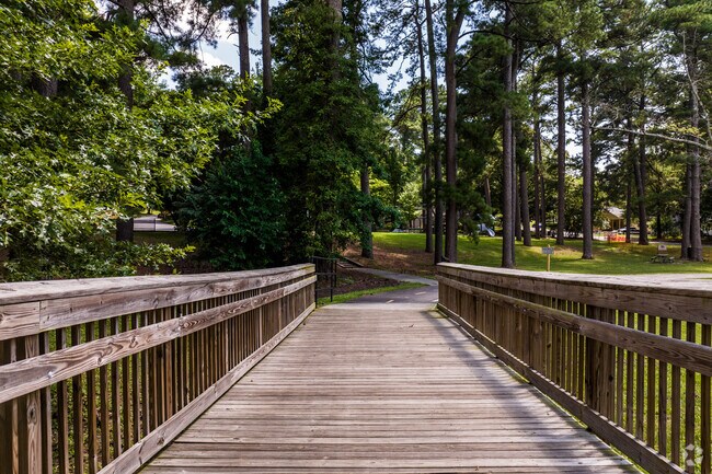 Westover Park in Duke Homestead has a trail with a wooden bridge.