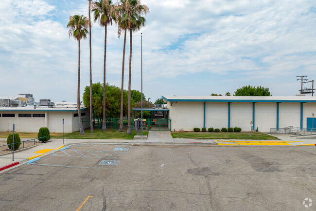 The entry to Elk Hills is line with palm trees.
