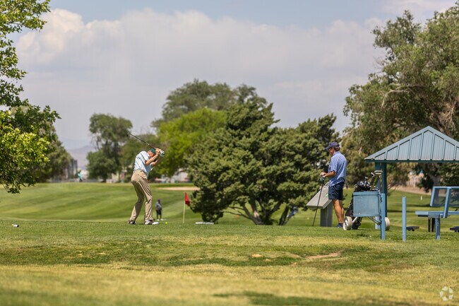 Golfers line up putts beneath trees at Los Altos Golf Course in South Los Altos.