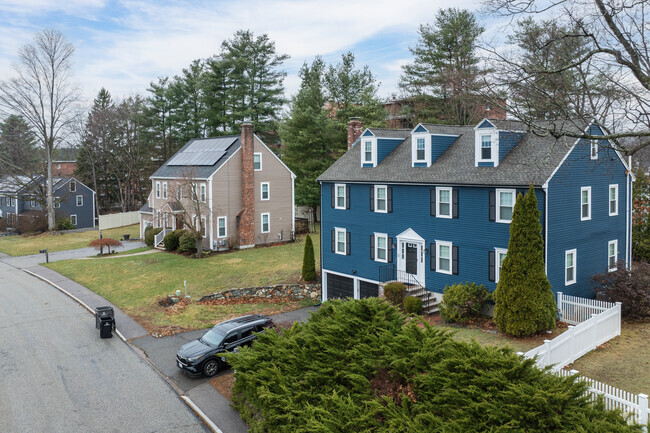 A picturesque row of stately Colonial homes lines Salem End Road, showcasing timeless architecture and historic charm.