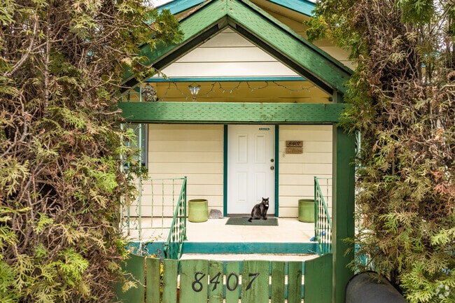 A black cat stands guard at the front door of this Sumner home in Portland, Oregon.