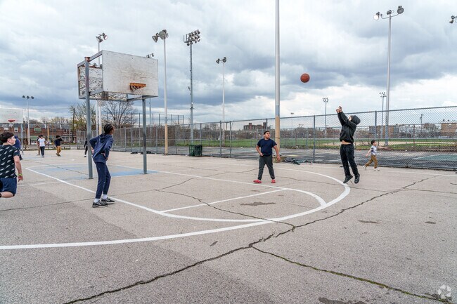Young, Juniata Park residents gather at Piccoli Park for a friendly game of basketball.