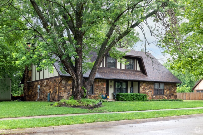 English-style home featuring Masonite and stone in Wolf Creek Estates.