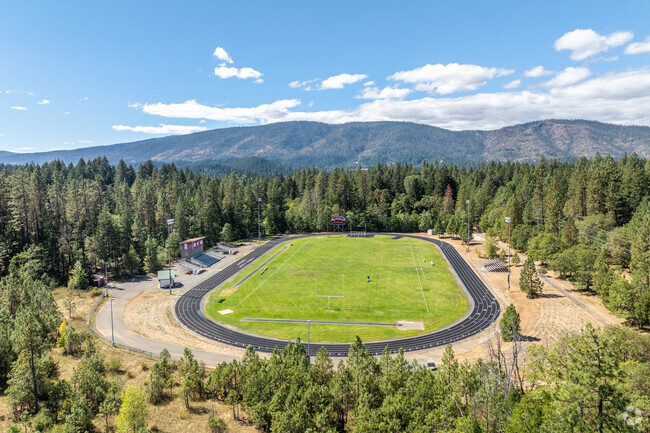 The track and football field at Illinois Valley High School is tucked into the woods.