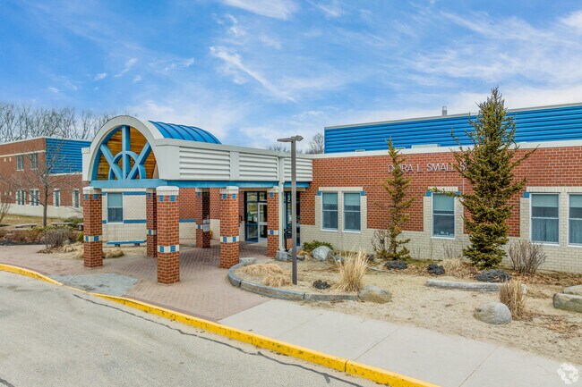 A covered walkway to the entrance of the Dora L. Small Elementary School.
