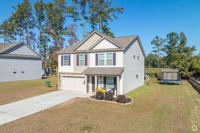 Contemporary multi-level houses in Olde Mill often have yards that go right up to the woods.