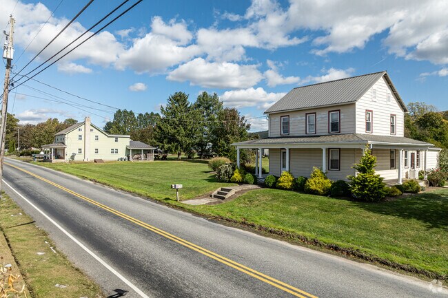 Houses with wraparound porches set on small farms are a common sight in Millcreek.