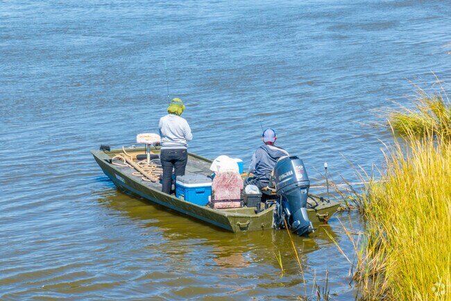 A couple fishing in the bayou on their motorboat in Dulac.