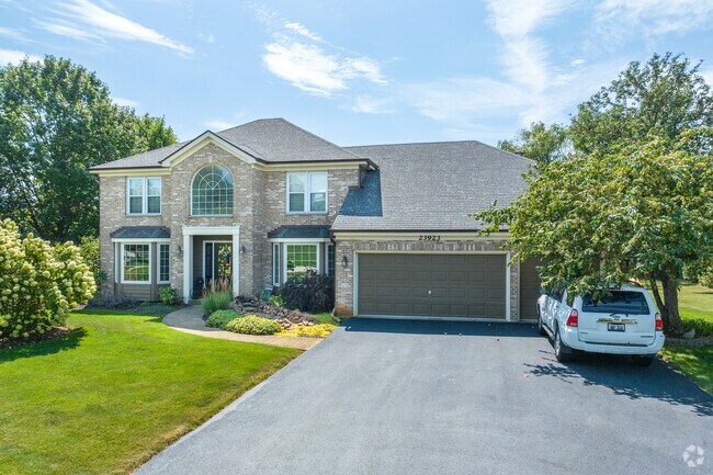 There are many Colonial-inspired homes with beautiful yards in the Clow Creek neighborhood.