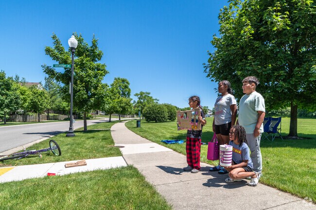 Neighborhood kids sell lemonade to passing cars adjacent to Heatherstone Community Park.