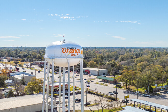 A water tower advertises the city of Orange.