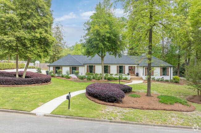 Mature trees and immaculate landscaping present this ranch home in its' best possible light.