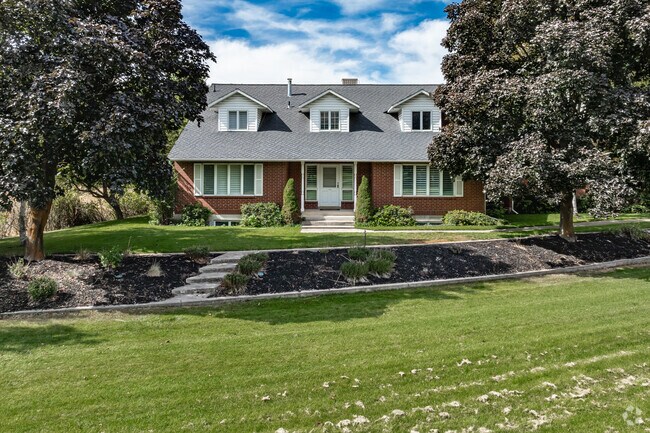 Trees from a Cape Cod style home with an extra large yard in Wilson.