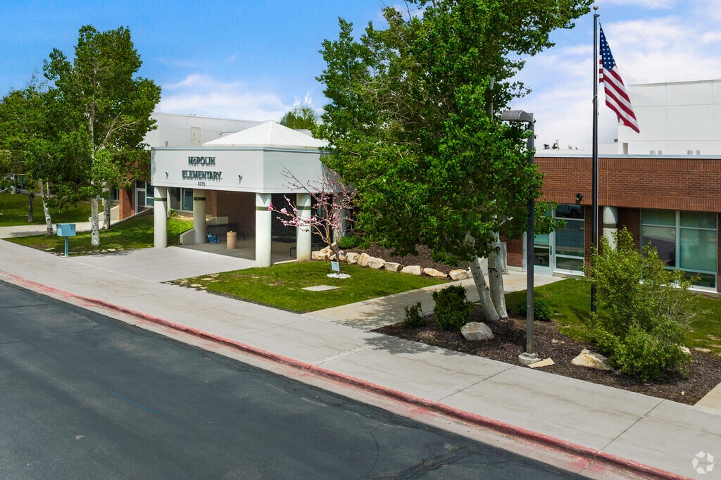 Green trees and a flag beautify the entrance of McPollin Elementary School in Park City.