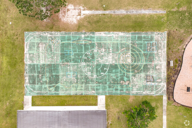 Jupiter Elementary School features a large outdoor sports court for students to play on.