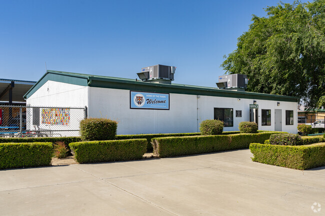 A large banner on the main building of Tamarack Elementary School welcomes Avenal students.