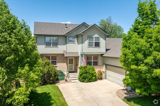 This two-story home in Country Hills is beautifully nestled among lush trees, featuring a lovely, well-manicured yard that enhances privacy and adds to the neighborhood’s natural charm.