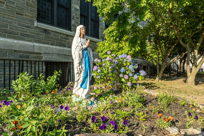 The Virgin Mary greets students as they arrive at Holy Name School.