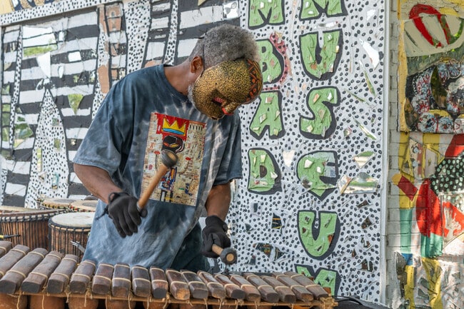 African storyteller and mask maker Efe Bes performs at Dabls Mbad African Bead Museum.