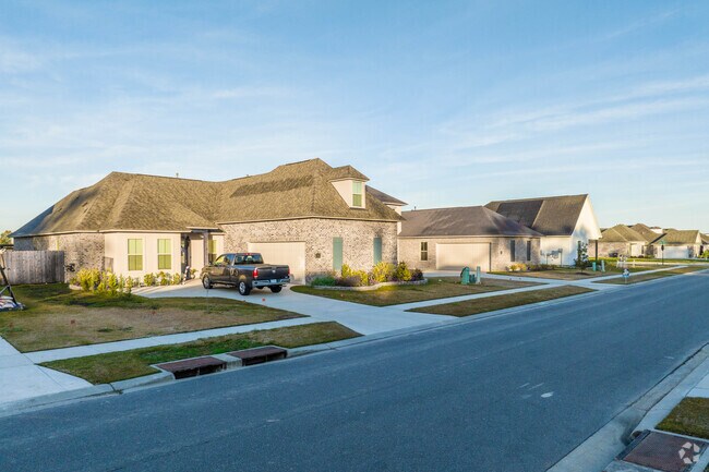 A row of brick homes along a quiet street in Darrow, Louisiana.