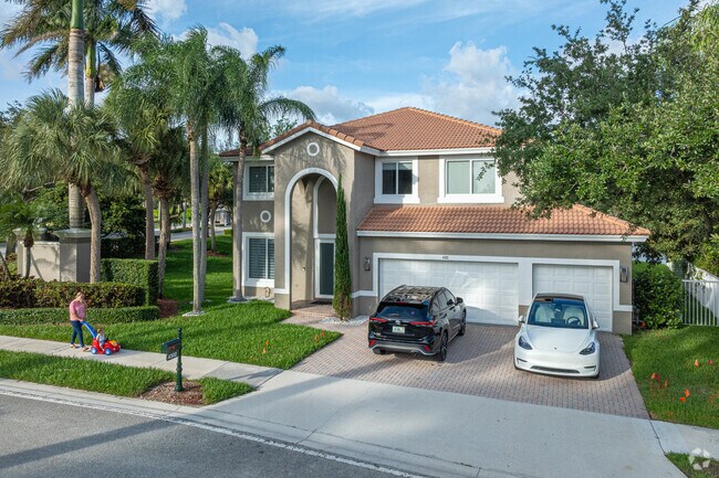 A few homes in Emerald Estates have three garages with wide driveways.