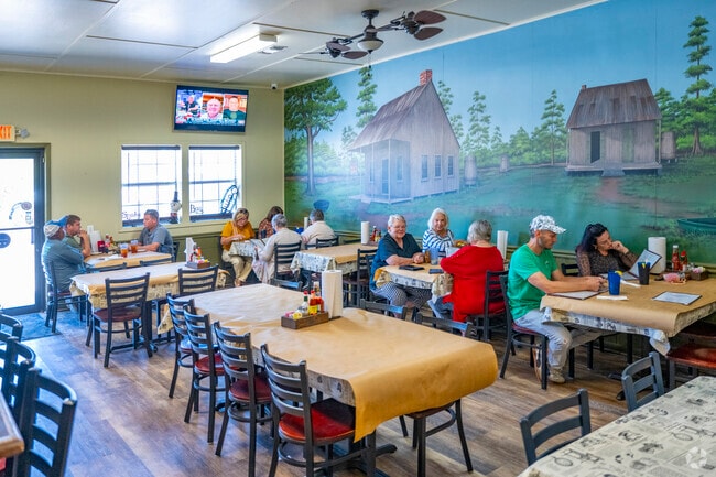 Murals depicting Cajun life cover the exterior walls of Cher Amie's Seafood.