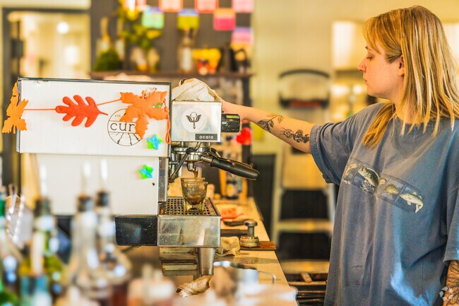 A latte to brighten your day, served with a smile at Cure Coffee Shop in Oyster Point.
