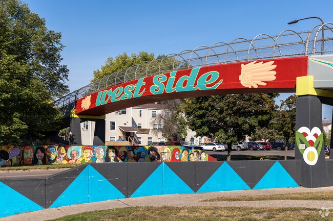 The West Side neighborhood is home to a famous pedestrian bridge adorned with colorful murals.